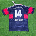 Bayern München soccer jersey with number 14 on a grass background